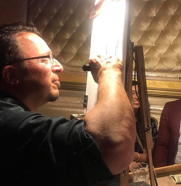 A man is painting on an easel
